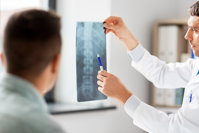 doctor showing x-ray to patient